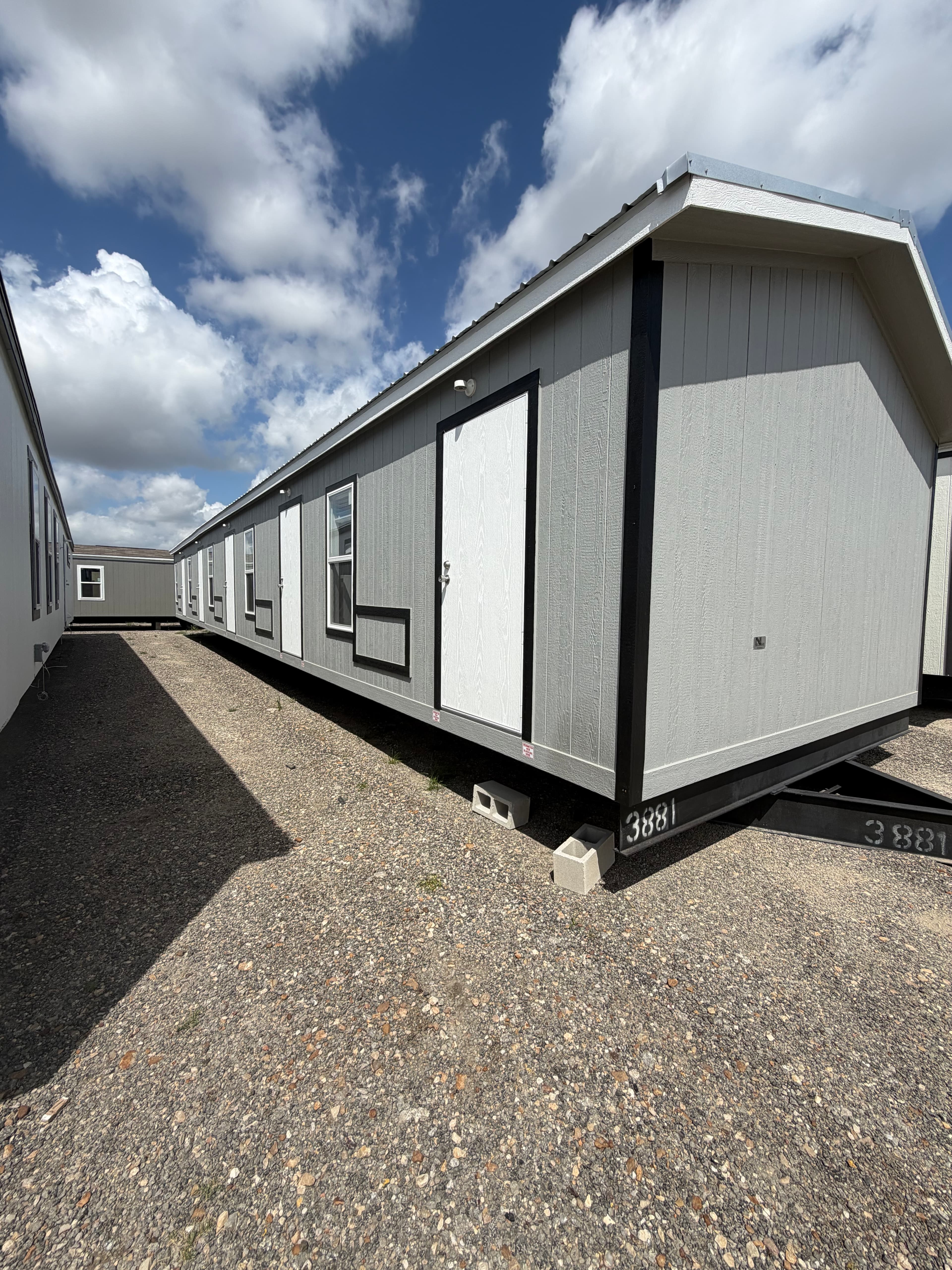 Iron Guard Lodging units staged on hydraulic transporters at the factory yard